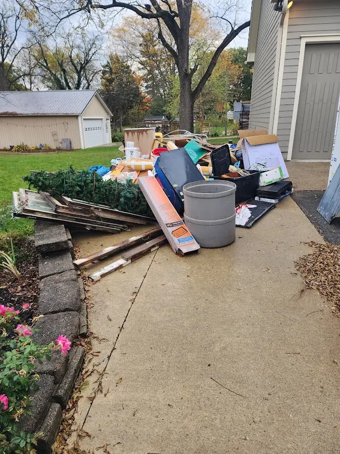 Dumpster being loaded with debris for Estate Cleanout Dumpster Rental in Santa Paula
